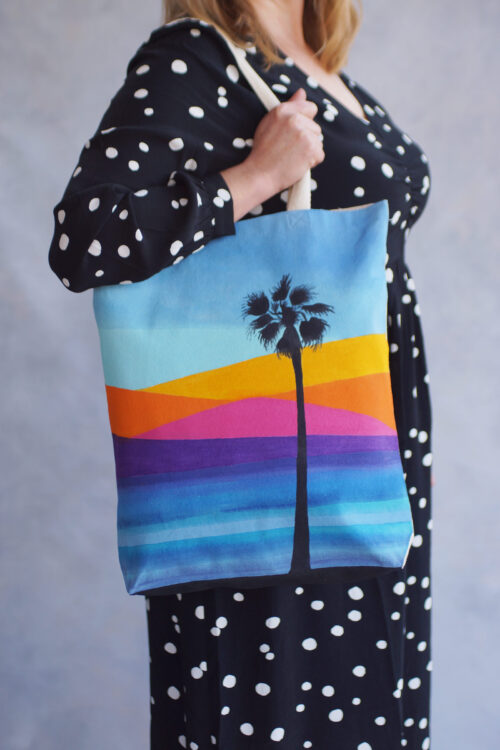 ocean sunset and palm tree tote bag in use