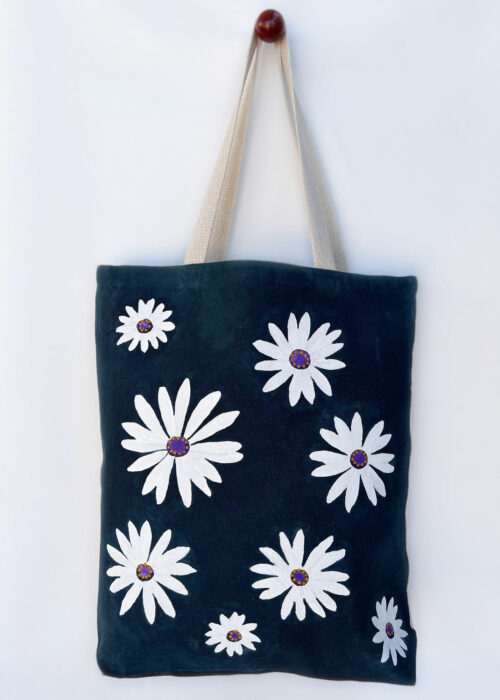 white chamomile on navy blue tote bag front view hanging