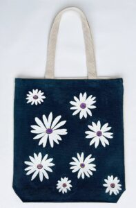 white chamomile on navy blue tote bag
