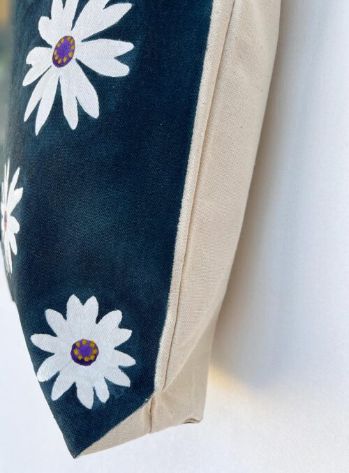 white chamomile on navy blue tote bag side view