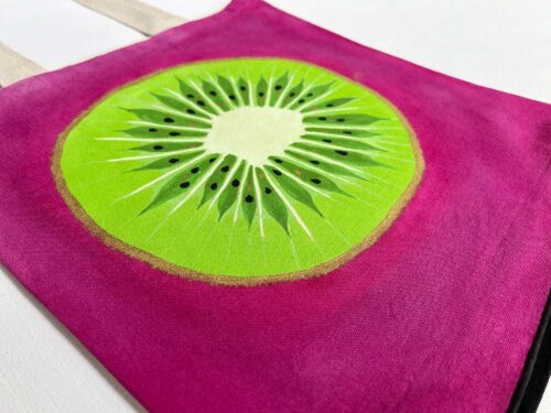 Green kiwi on pink background tote bag zoom in detail