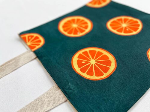 oranges on dark green background tote bag zoom in detail
