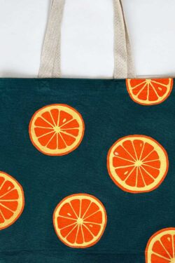 oranges on dark green background tote bag
