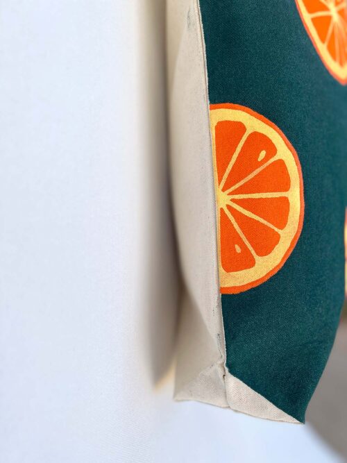 oranges on dark green background tote bag side view