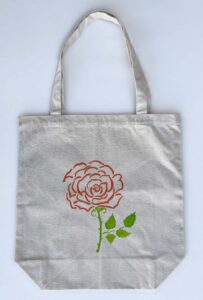 rose and succulent plant in a pot tote bag rose