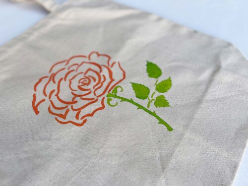 rose and succulent plant in a pot tote bag zoom in rose detail