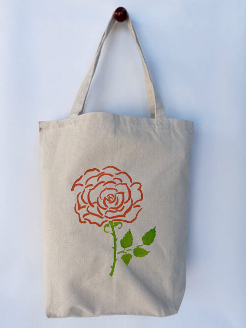 rose and succulent plant in a pot tote bag hanging