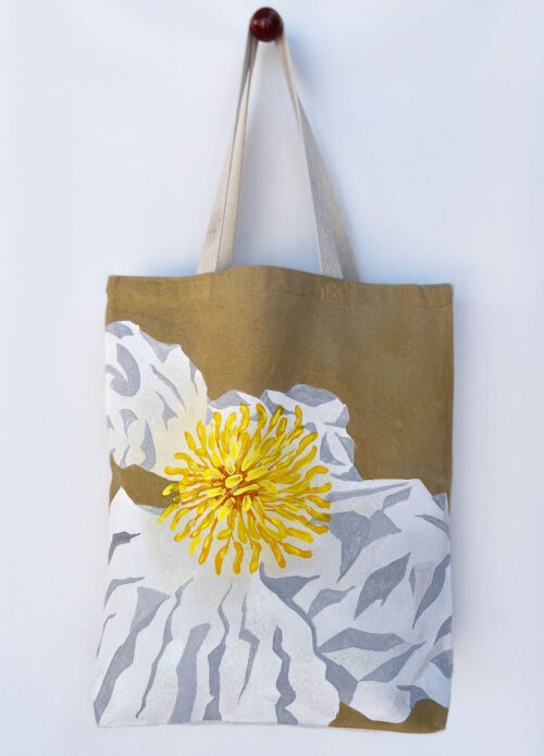 white poppy on golden background tote bag hanging front view