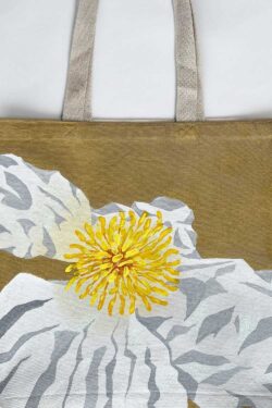 white poppy on golden background tote bag